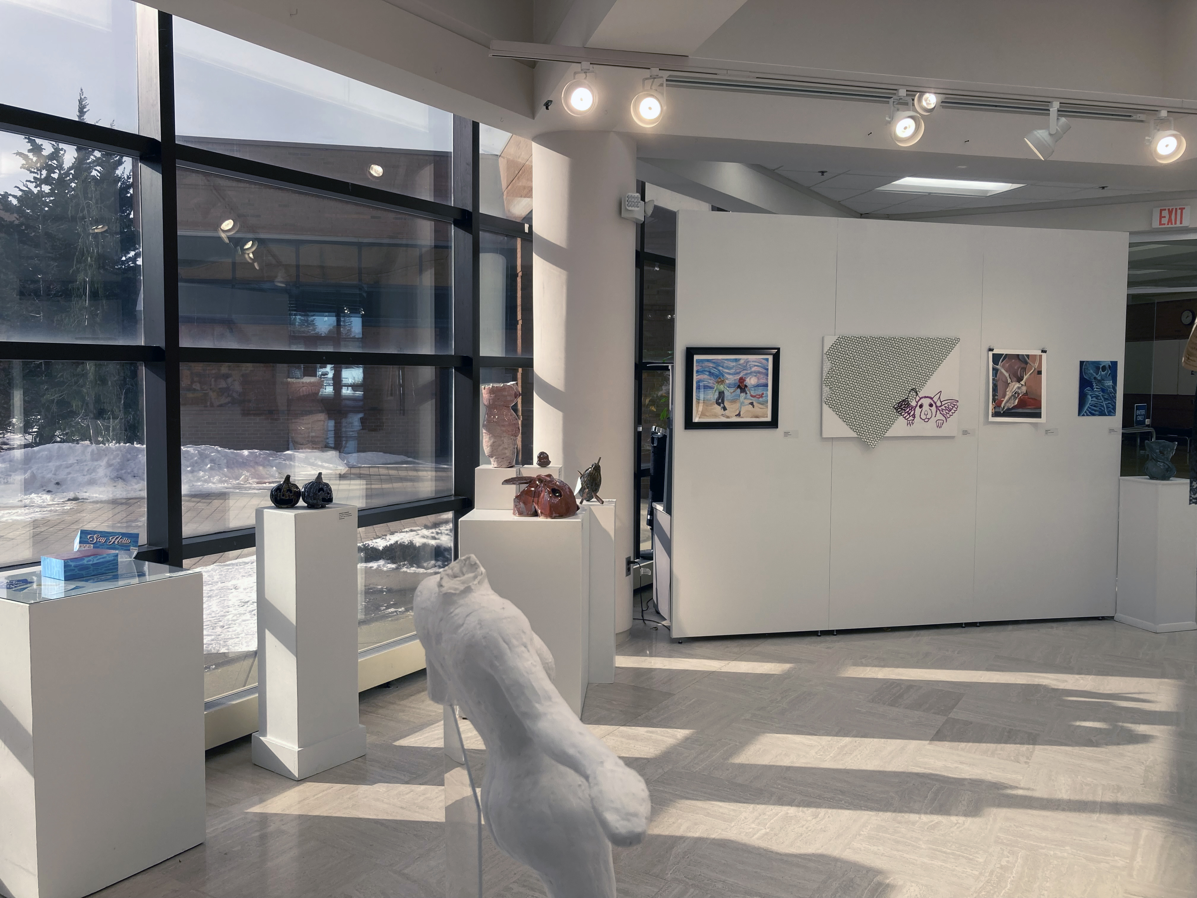 17th annual Student Art Exhibit looking west from outer window side. Various art works shown.